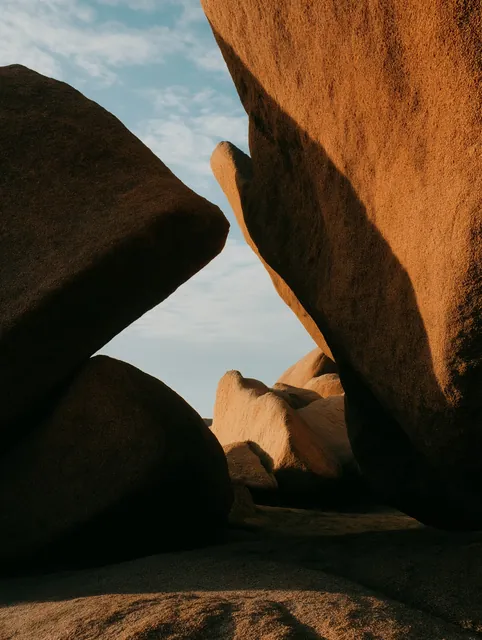A desert rock arch under a pale sky